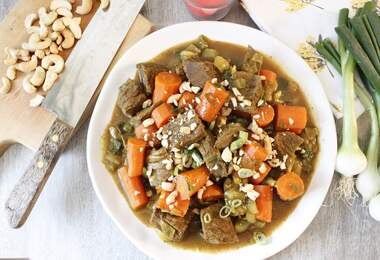 Plato de guiso de vegetales con zanahorias, cebolla y castañas de cajú troceadas