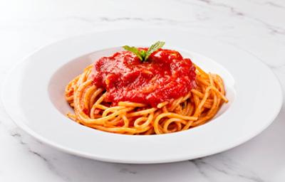 La salsa pomodoro combina muy bien con las pastas. Espagueti con salsa pomodoro, servido en un plato blanco