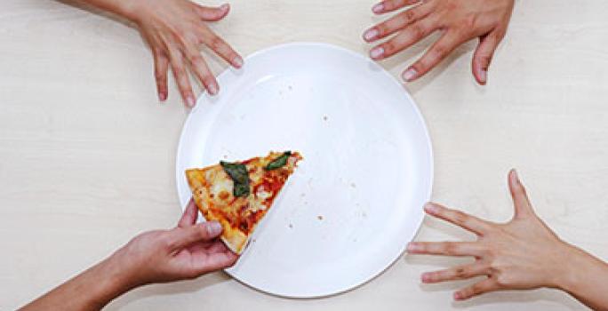 Plato con pizza y manos para calcular porciones de alimentos Plato con pizza y manos para calcular porciones de alimentos