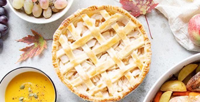 Mesa con preparaciones y pie postre con manzana Mesa con preparaciones y pie postre con manzana